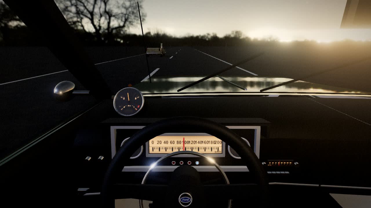 Vista interior del habitáculo con el tablero, el volante y el camino al atardecer por el parabrisas